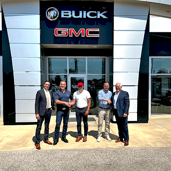 A Group of Men Outside a Buick Building
