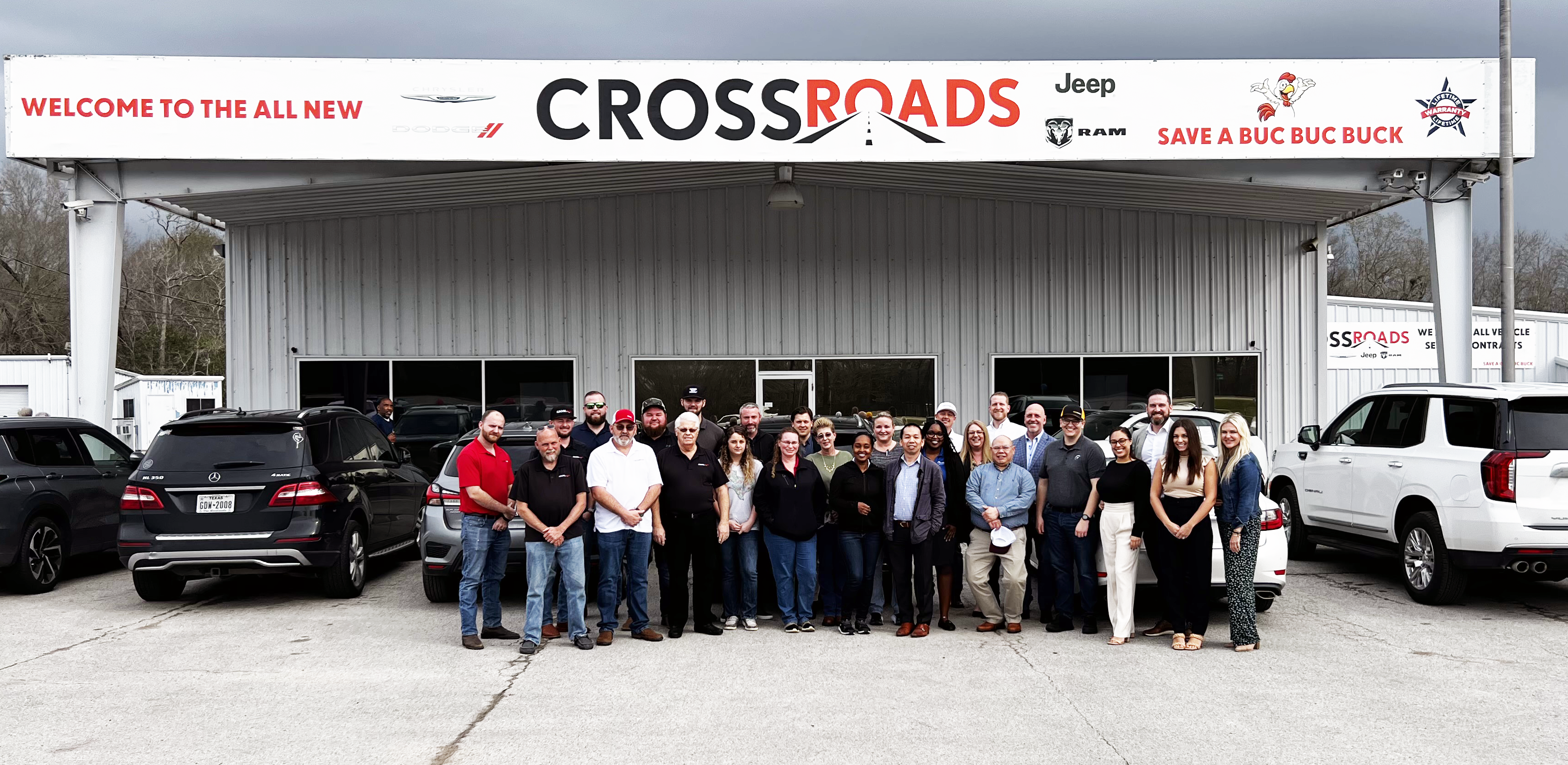 A Group of People Standing Outside a Cross Roads Store